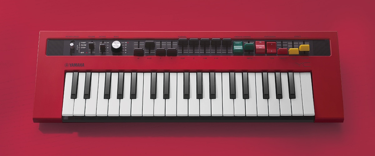 Small red piano keyboard with lots of sliders.